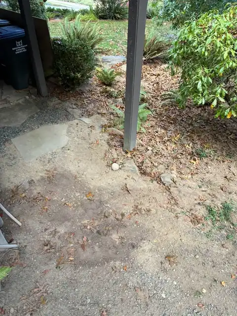 Gravel restored around a deck post after trenching