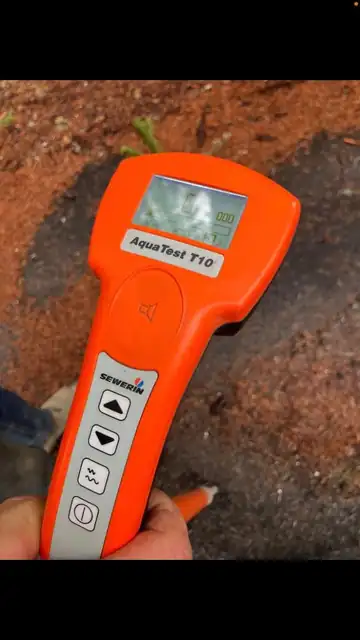 Sewerin AquaTest T10 electronic leak detection receiver held by a technician