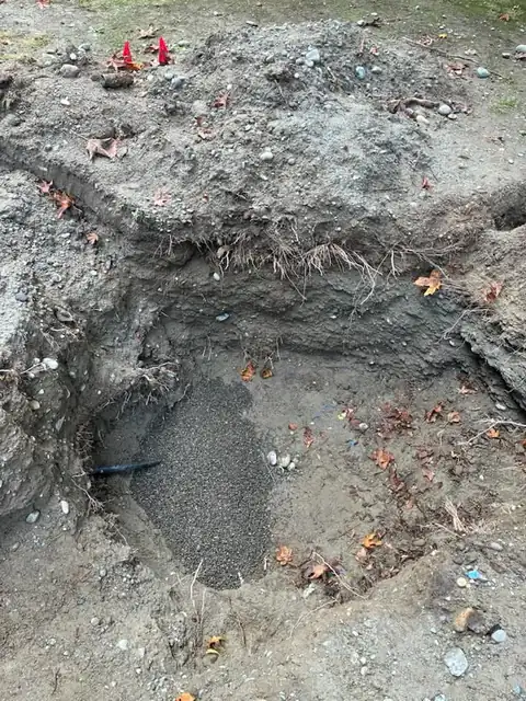 Pea gravel bedding around a new black water line in an excavation
