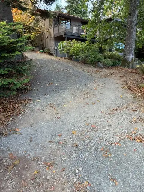 Gravel driveway restored below a hillside home